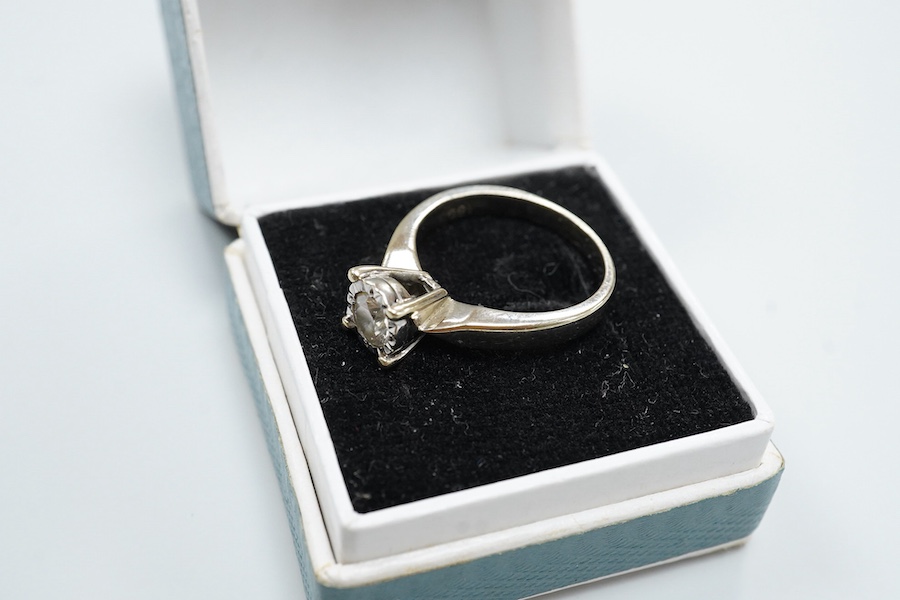 An 18ct and illusion set solitaire diamond ring, the stone weighing approximately 0.30ct, size K, gross weight 4.2 grams.